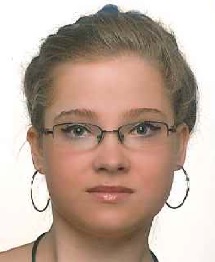 Zdjęcie przedstawia kobietę w okularach i w kolczykach
