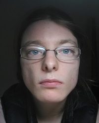 Zdjęcie przedstawia kobietę w okularach